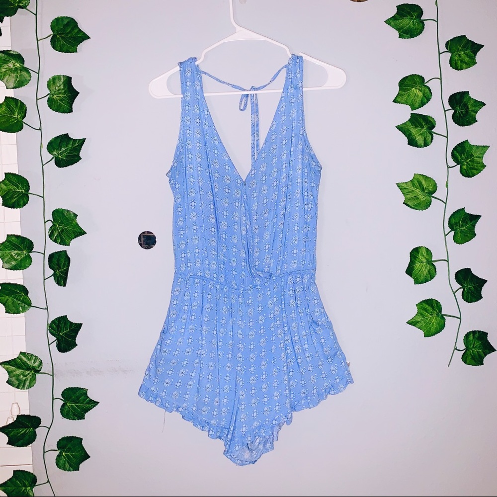 Pale blue romper with floral designs and open back
